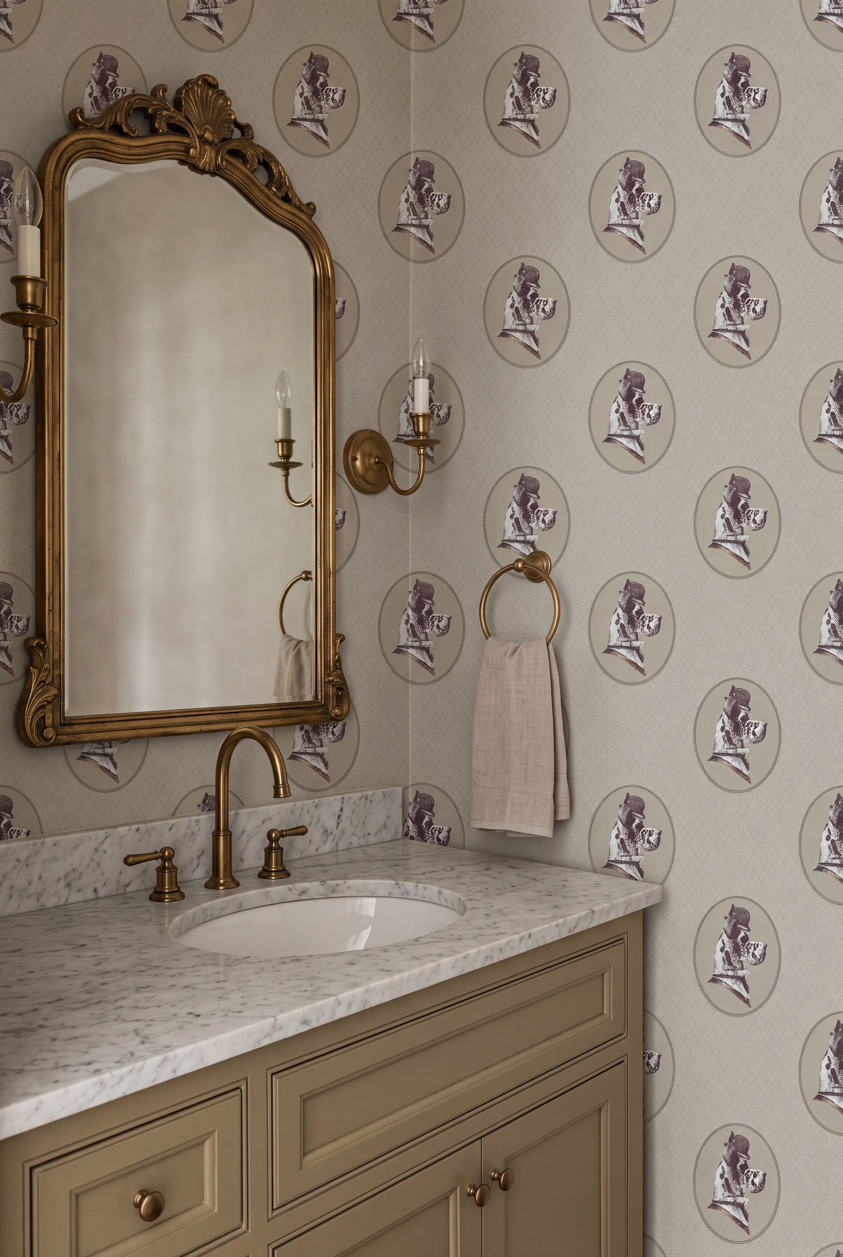 Cream floral cameo wallpaper in a powder room.
