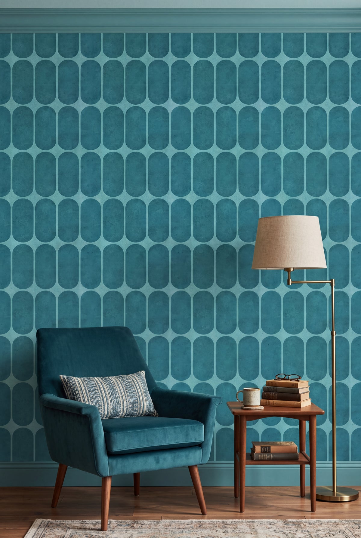 Deep teal capsule grid wallpaper in a cozy reading nook.