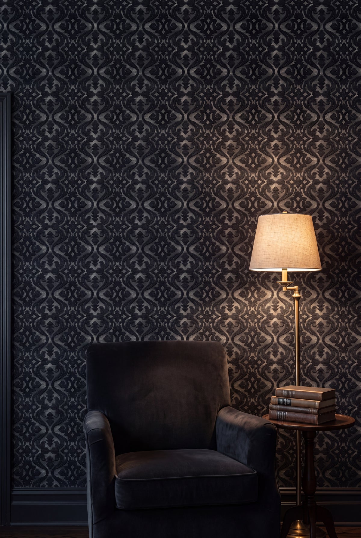 Black scroll damask wallpaper in a cozy reading nook.