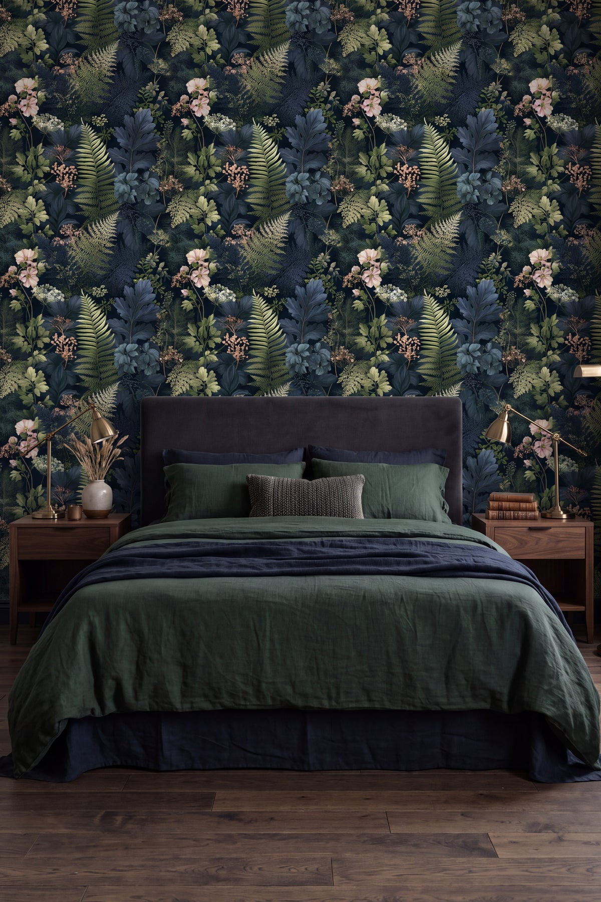 Teal ferns and pale blooms on dark navy botanical wallpaper behind a bed.