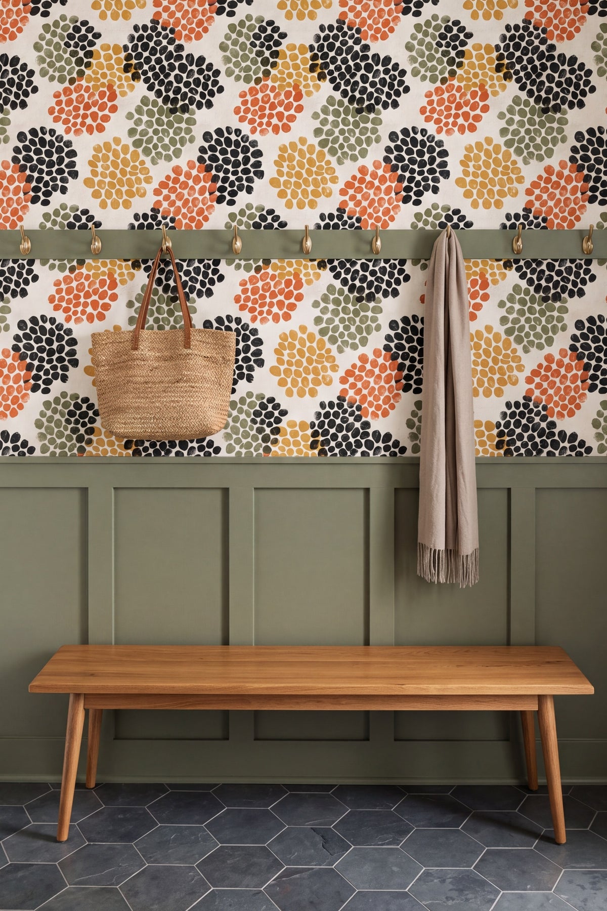 Terracotta and mustard seedpod dot wallpaper on cream in a mudroom with painted millwork.