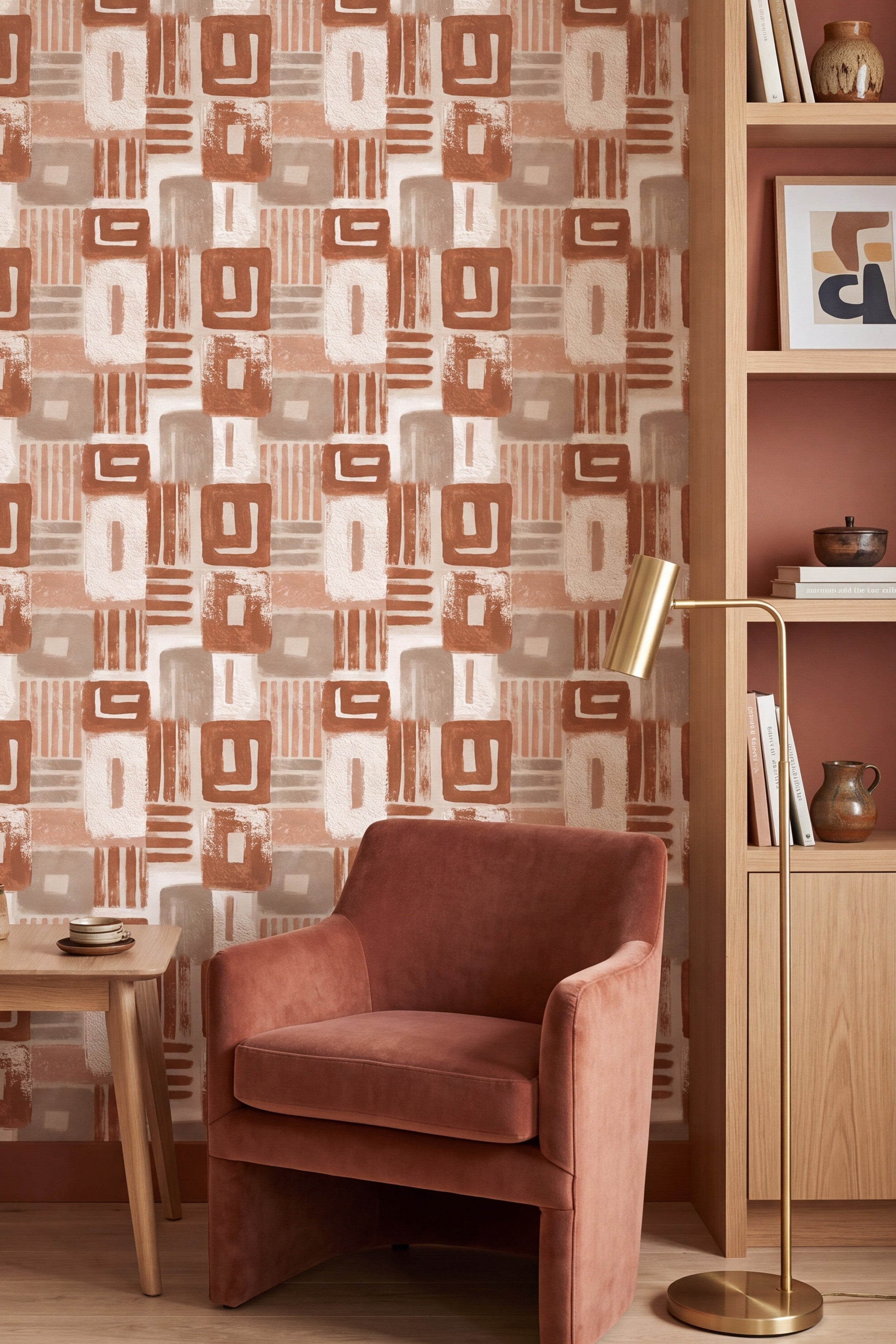 Muted tan and rust rectangles with hatch lines on cream wallpaper in a reading nook.