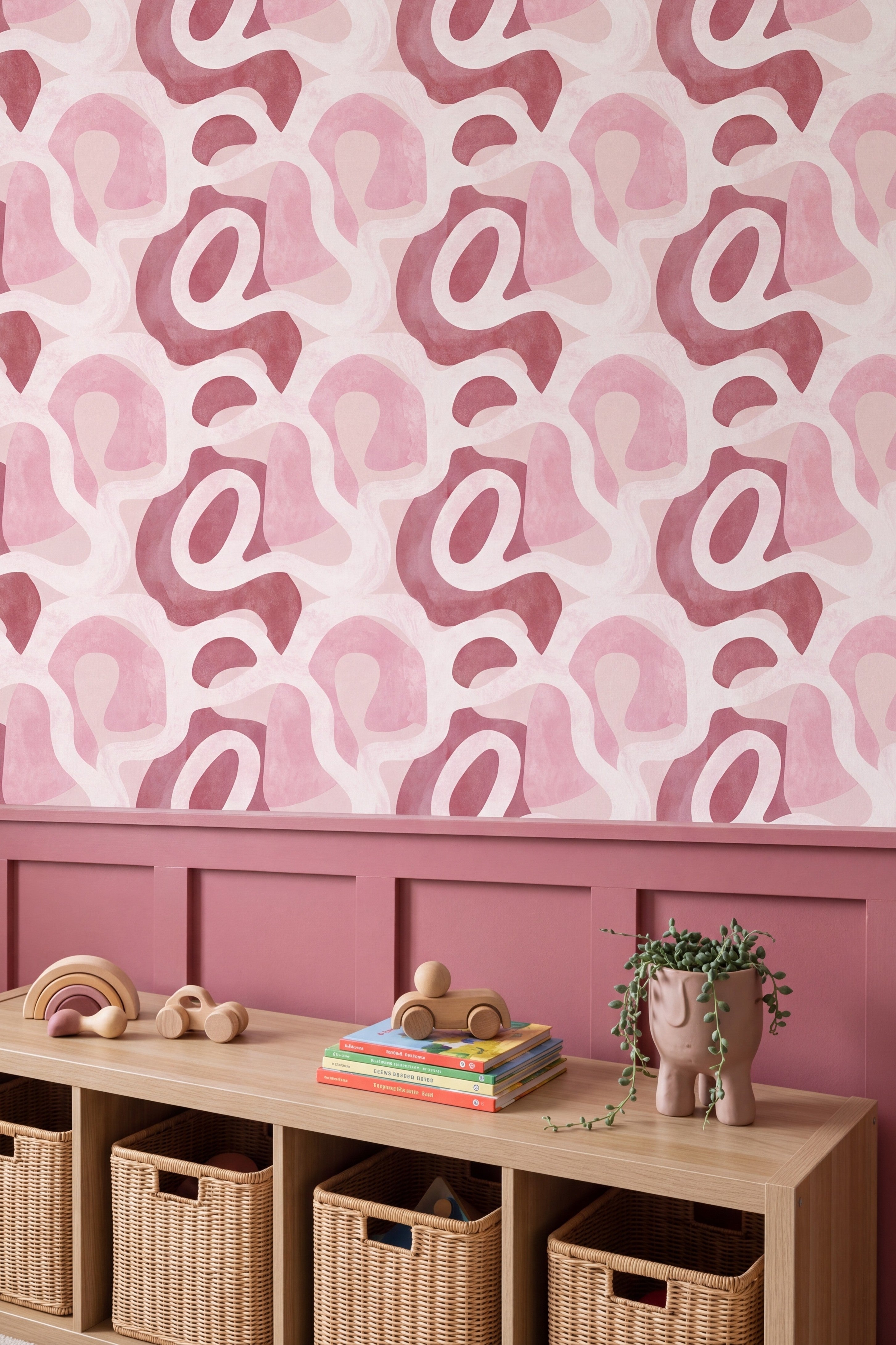 Berry pink organic shapes wallpaper in a kids room with painted trim.
