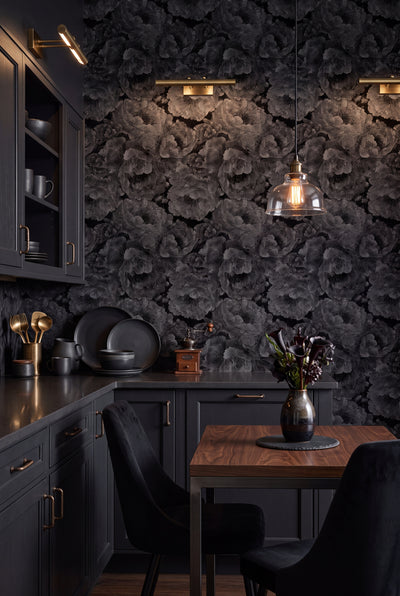 Charcoal peony blossoms on a near-black chinoiserie wallpaper in a cozy nook.