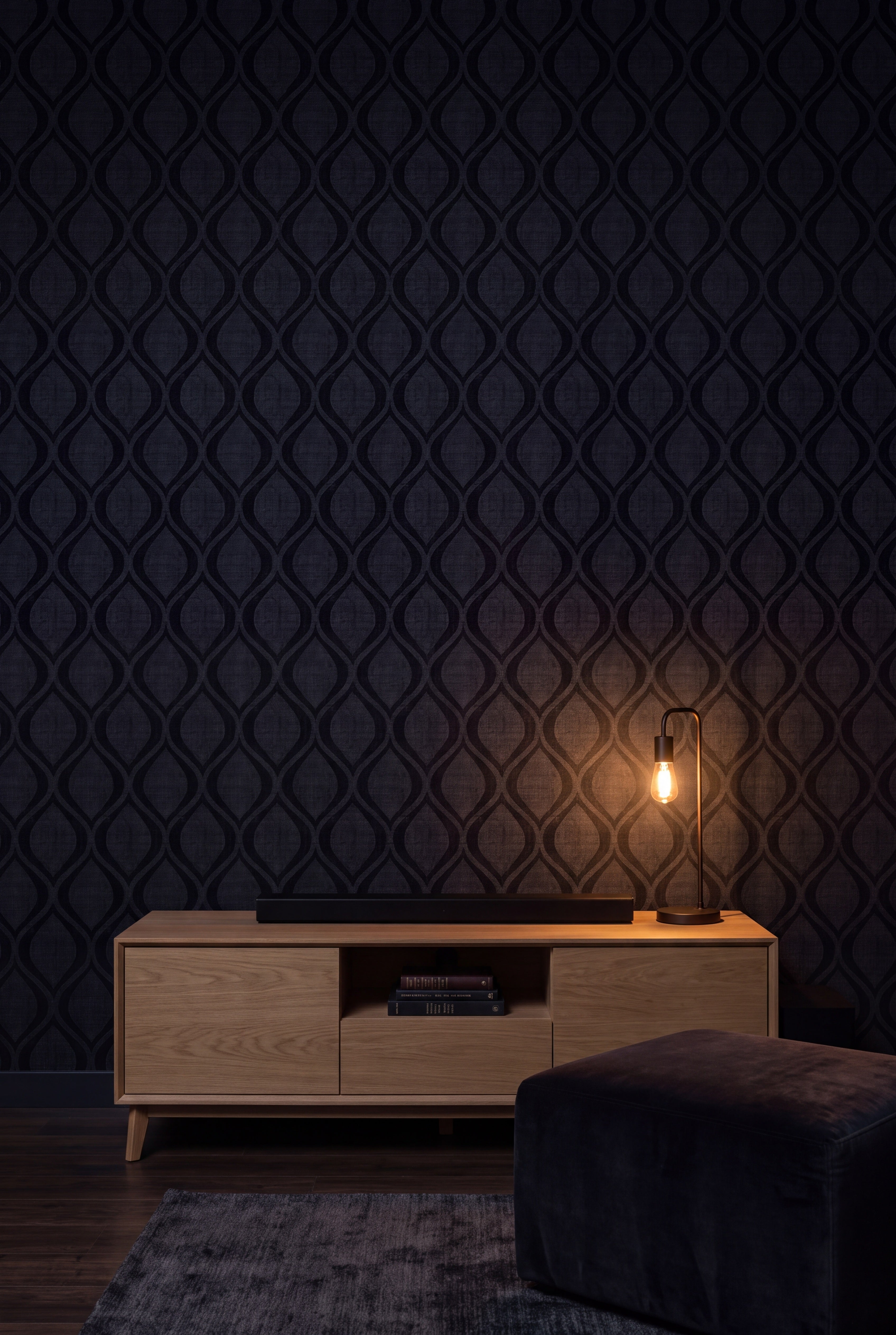 Midnight Ogee wallpaper in tonal navy and charcoal on a media wall.