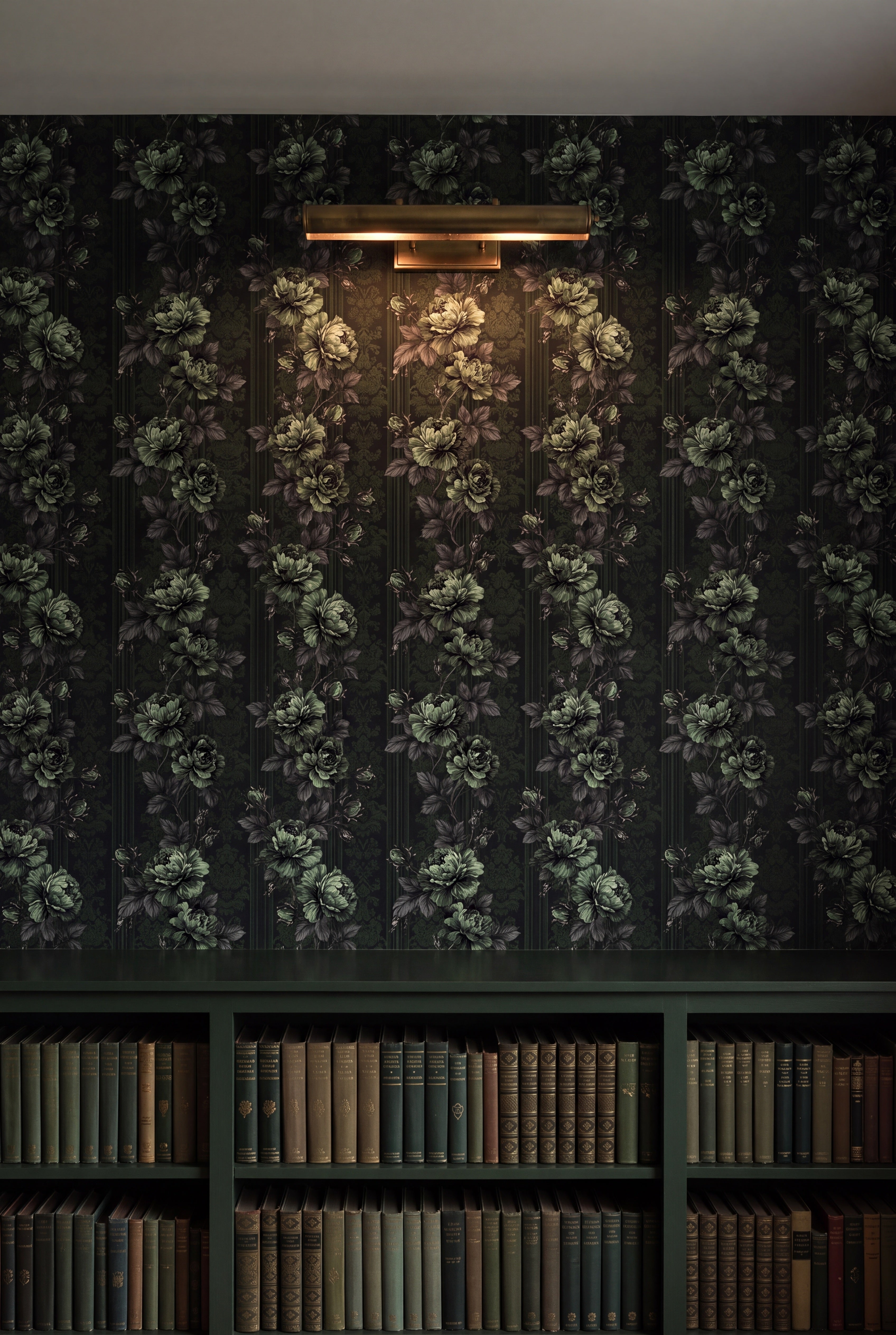 Ivy Nocturne wallpaper in sage and forest green on near black on a library wall.