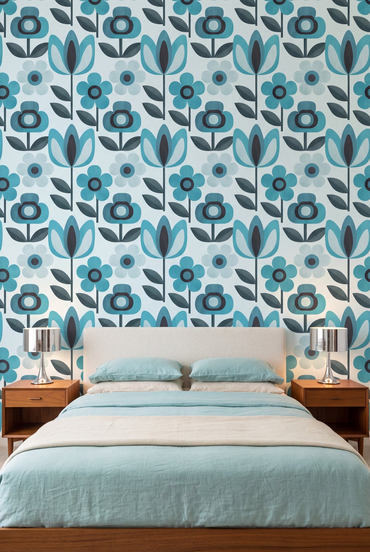 Aqua Daisy wallpaper in teal and aqua on pale ice blue on a bedroom wall.