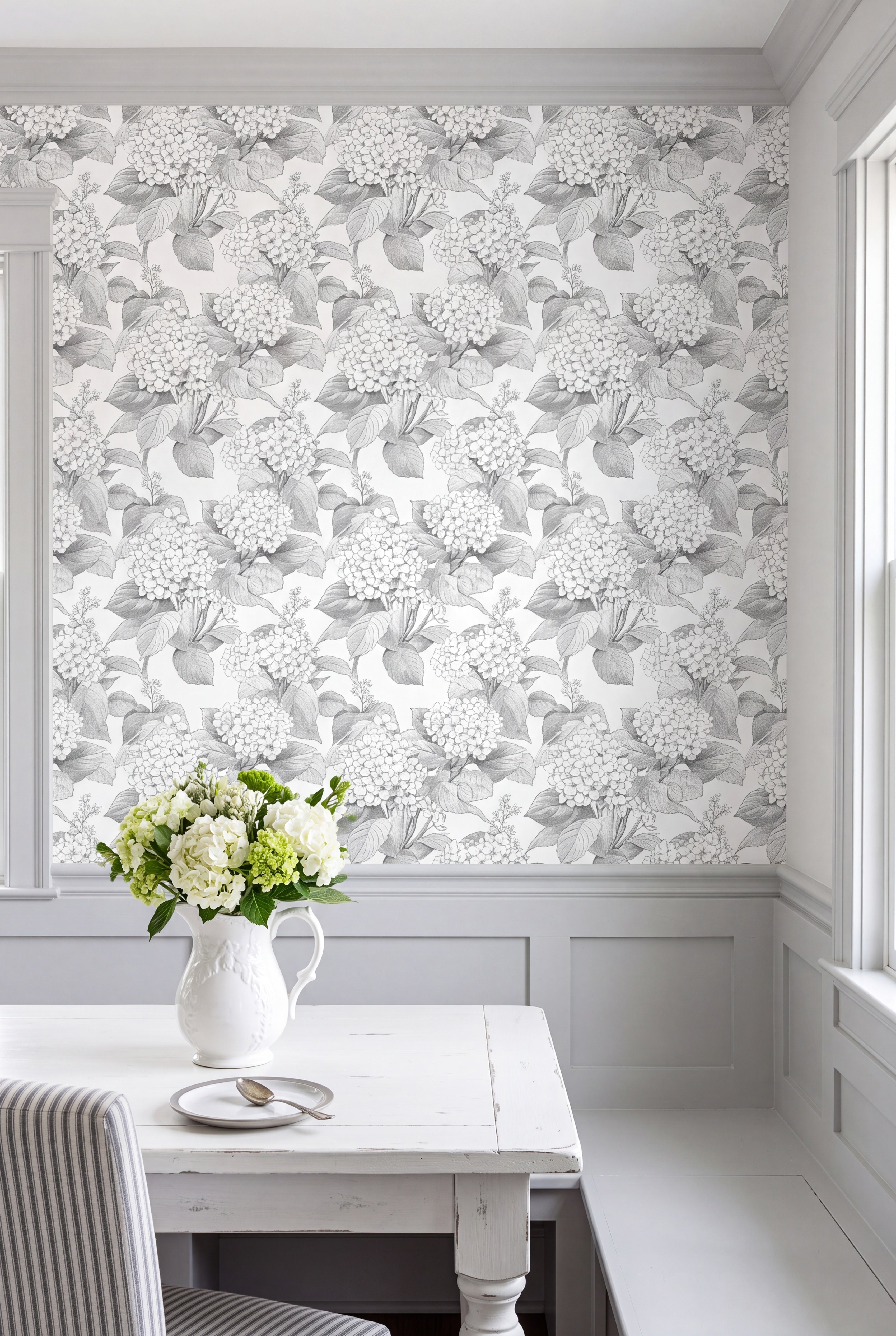 Black-and-white hydrangea blooms on a monochrome wallpaper in a cozy nook.