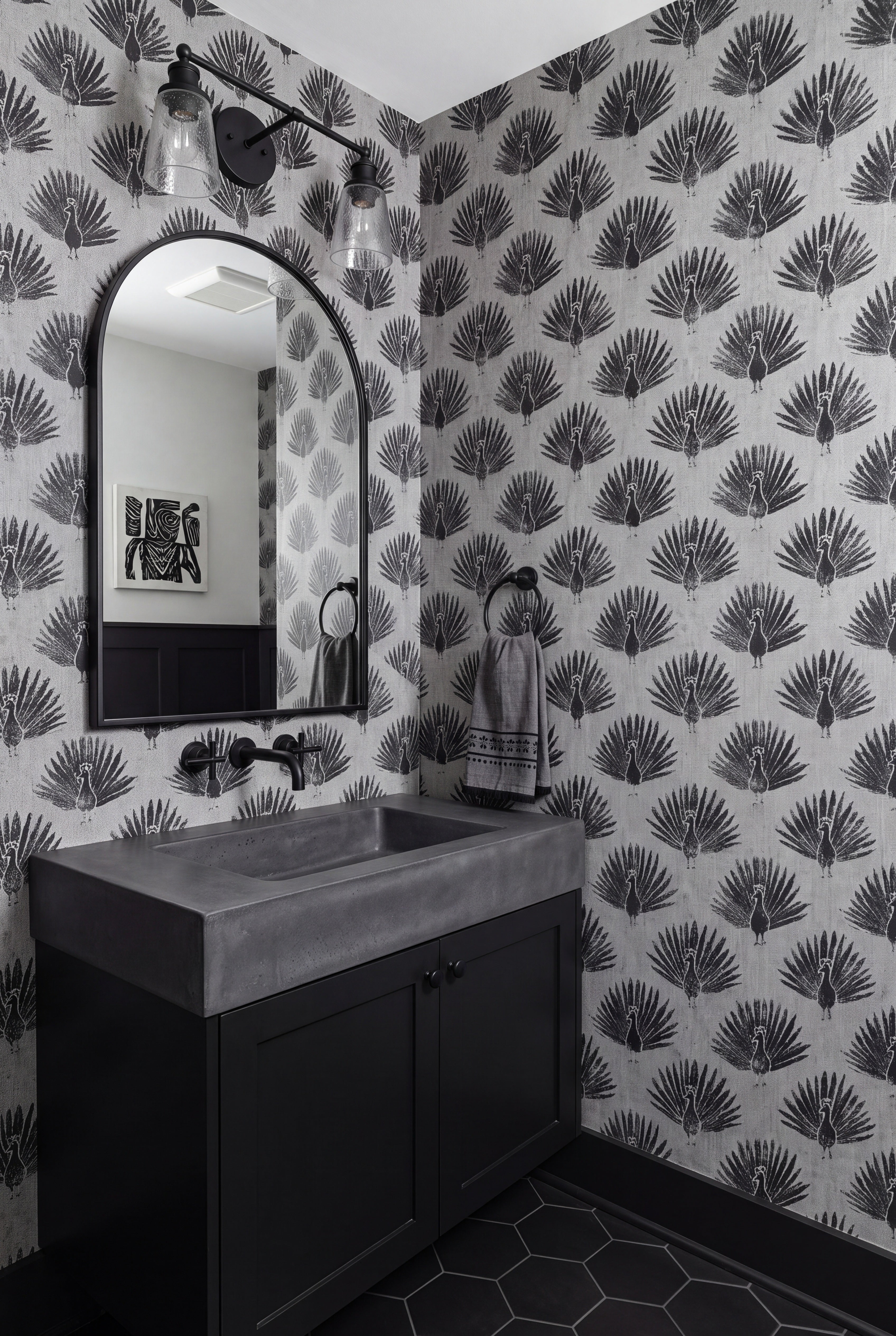 Peacock Noir wallpaper shown in a powder room